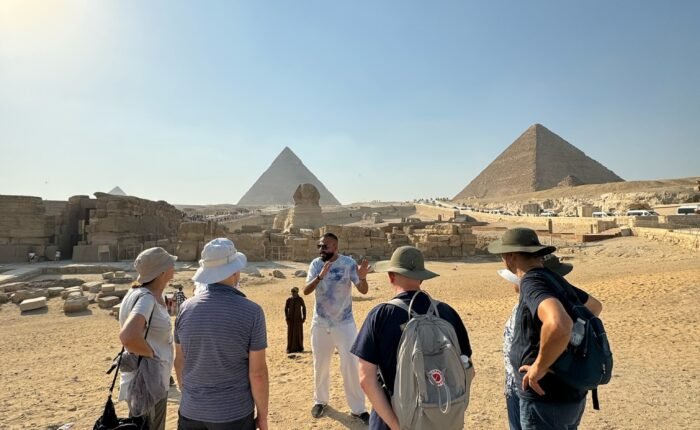Travellers walking towards the Pyramids of Giza on a Crossroads Egypt tour
