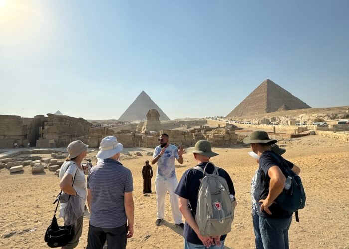 Travellers walking towards the Pyramids of Giza on a Crossroads Egypt tour