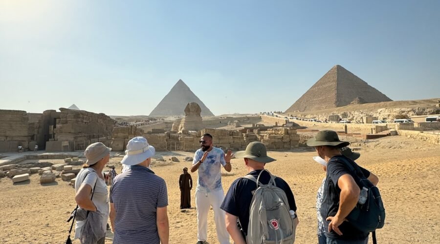 Travellers walking towards the Pyramids of Giza on a Crossroads Egypt tour