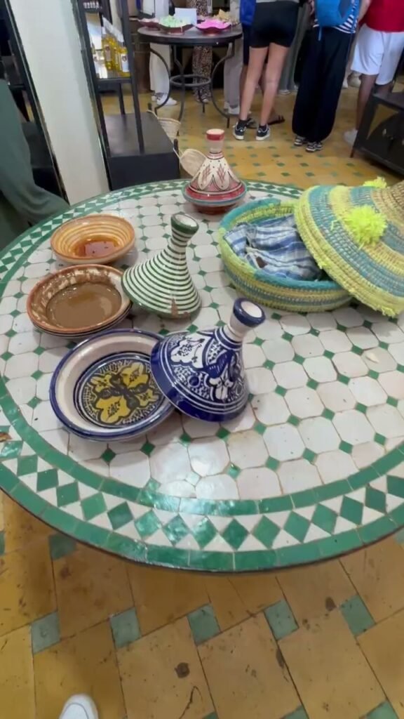 Hand-painted Moroccan ceramic tagines and bowls on a zellige tile table