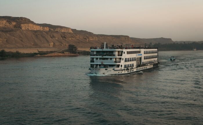 Nile cruise ship sailing past the desert hills of Aswan
