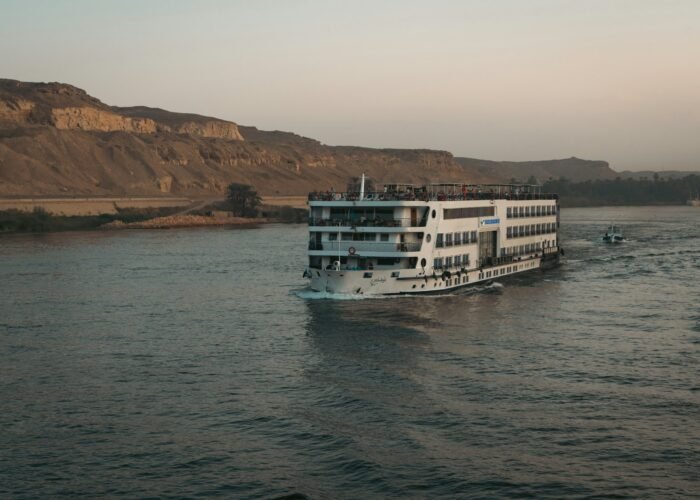 Nile cruise ship sailing past the desert hills of Aswan