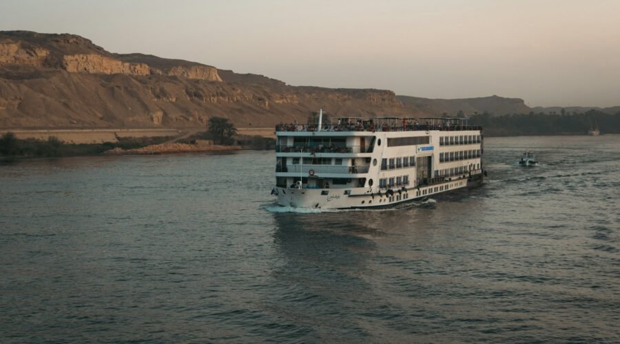Nile cruise ship sailing past the desert hills of Aswan