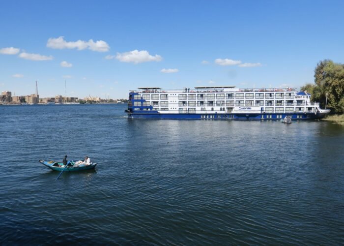 White Nile cruise ship on the river in Luxor under a blue sky