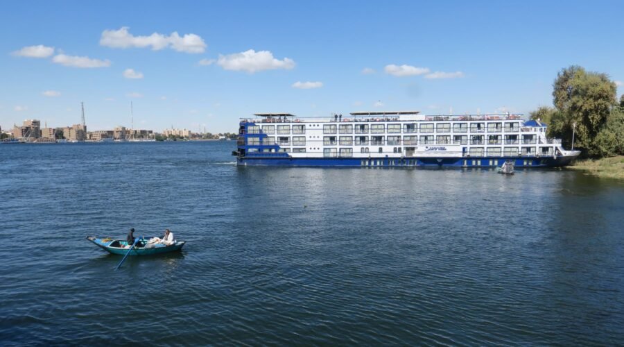 White Nile cruise ship on the river in Luxor under a blue sky